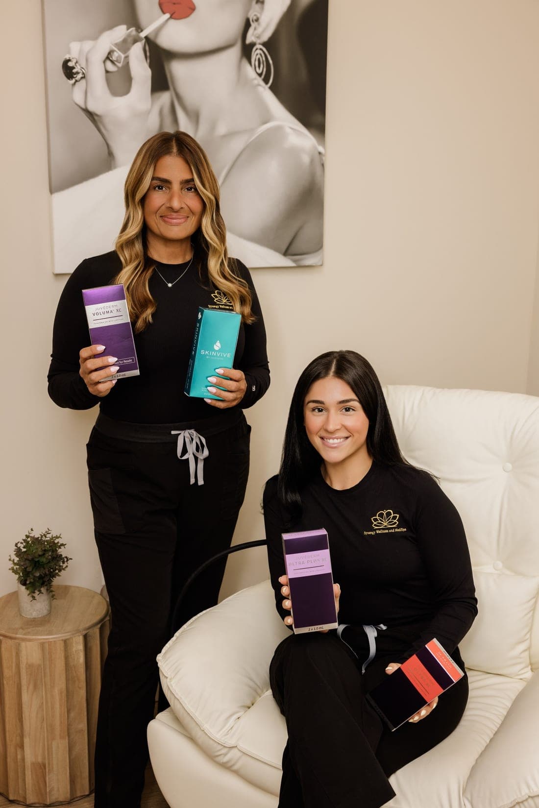 Two Synergy team members with professional filler and skincare products.